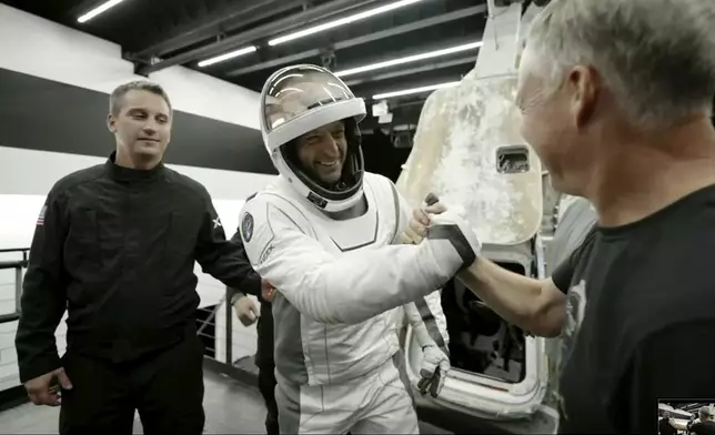 In this image made from SpaceX video, tech entrepreneur Jared Isaacman, center, greets as he gets out of its capsule upon his return with his crew after the capsule landed in the Gulf of Mexico near Florida's Dry Tortugas early Sunday, Sept. 15, 2024. (SpaceX via AP)