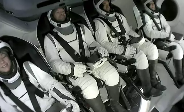 This image made from SpaceX video shows the four-member crew including tech entrepreneur Jared Isaacman, third left, seated in its capsule as they wait to get off the capsule after it landed in the Gulf of Mexico near Florida's Dry Tortugas early Sunday, Sept. 15, 2024. (SpaceX via AP)