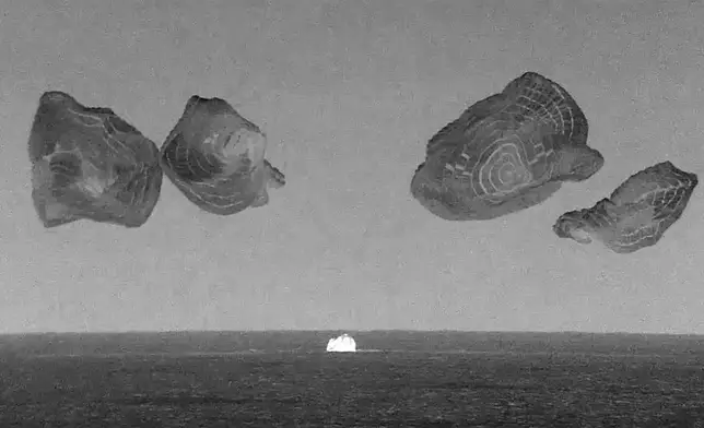 This black and white, thermal image made from SpaceX video shows its capsule, center, carrying tech entrepreneur Jared Isaacman with his crew after it reached the Gulf of Mexico near Florida's Dry Tortugas early Sunday, Sept. 15, 2024. (SpaceX via AP)