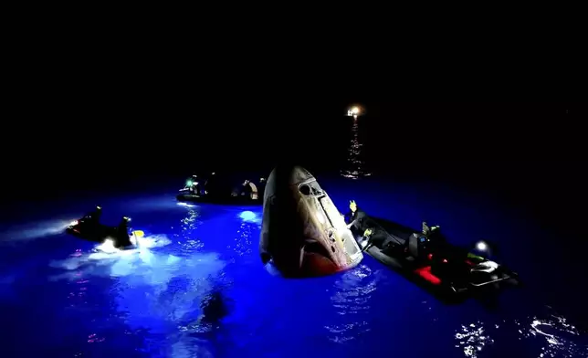 This image made from SpaceX video shows its capsule, center, carrying tech entrepreneur Jared Isaacman with his crew after it reached the Gulf of Mexico near Florida's Dry Tortugas early Sunday, Sept. 15, 2024. (SpaceX via AP)