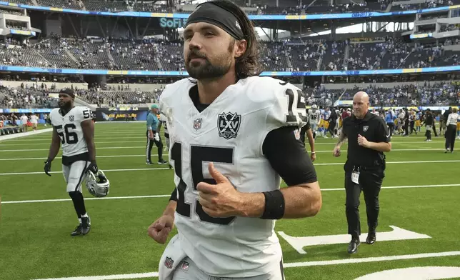 Las Vegas Raiders quarterback Gardner Minshew II jogs off the field after the Raiders were defeated by the Los Angeles Chargers in an NFL football game, Sunday, Sept. 8, 2024, in Inglewood, Calif. (AP Photo/Marcio Jose Sanchez)