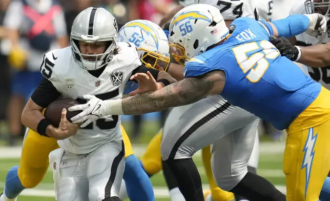 Las Vegas Raiders quarterback Gardner Minshew II (15) is sacked by Los Angeles Chargers defensive end Morgan Fox (56) and linebacker Khalil Mack (52) during the first half of an NFL football game, Sunday, Sept. 8, 2024, in Inglewood, Calif. (AP Photo/Ashley Landis)