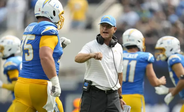 Los Angeles Chargers center Bradley Bozeman, left, is congratulated by head coach Jim Harbaugh after a field goal against the Las Vegas Raiders during the first half of an NFL football game, Sunday, Sept. 8, 2024, in Inglewood, Calif. (AP Photo/Ashley Landis)