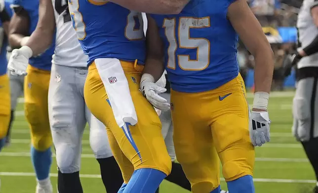 Los Angeles Chargers wide receiver Ladd McConkey (15) is congratulated by tight end Hayden Hurst (88) after scoring a touchdown against the Las Vegas Raiders during the second half of an NFL football game, Sunday, Sept. 8, 2024, in Inglewood, Calif. (AP Photo/Marcio Jose Sanchez)