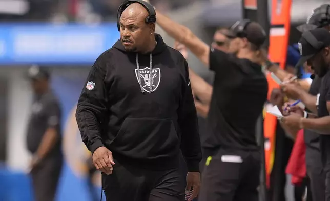 Las Vegas Raiders head coach Antonio Pierce walks on the sideline during the first half of an NFL football game against the Los Angeles Chargers, Sunday, Sept. 8, 2024, in Inglewood, Calif. (AP Photo/Marcio Jose Sanchez)