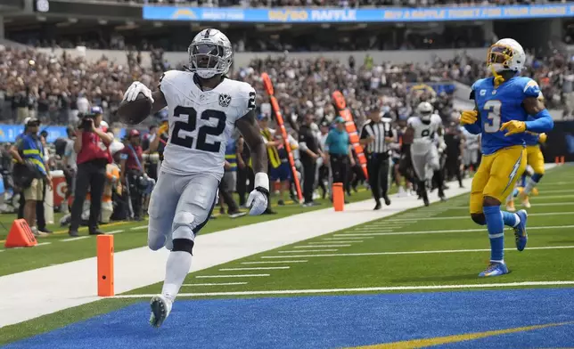 Las Vegas Raiders running back Alexander Mattison (22) runs for a touchdown against the Los Angeles Chargers during the first half of an NFL football game, Sunday, Sept. 8, 2024, in Inglewood, Calif. (AP Photo/Marcio Jose Sanchez)