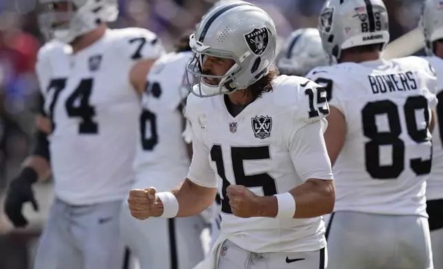 Las Vegas Raiders quarterback Gardner Minshew (15) celebrates after running back Alexander Mattison scored a touchdown against the Baltimore Ravens during the second half of an NFL football game, Sunday, Sept. 15, 2024, in Baltimore. (AP Photo/Stephanie Scarbrough)