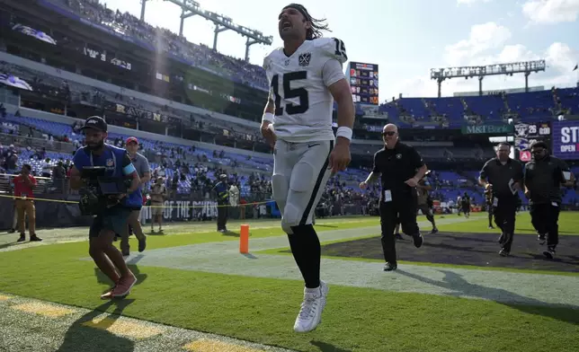 Las Vegas Raiders quarterback Gardner Minshew (15) celebrates after the Las Vegas Raiders defeated the Baltimore Ravens in an NFL football game, Sunday, Sept. 15, 2024, in Baltimore. (AP Photo/Stephanie Scarbrough)