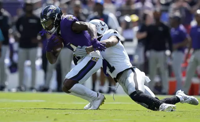 Las Vegas Raiders safety Marcus Epps (1) tackles Baltimore Ravens wide receiver Zay Flowers (4) during the first half of an NFL football game, Sunday, Sept. 15, 2024, in Baltimore. (AP Photo/Stephanie Scarbrough)