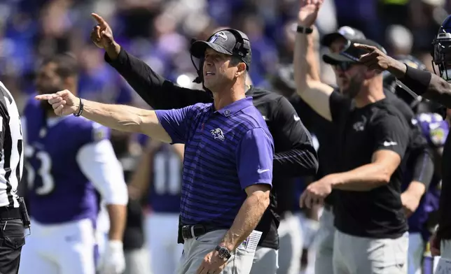 Baltimore Ravens head coach John Harbaugh motions towards the field during the first half of an NFL football game against the Las Vegas Raiders, Sunday, Sept. 15, 2024, in Baltimore. (AP Photo/Nick Wass)