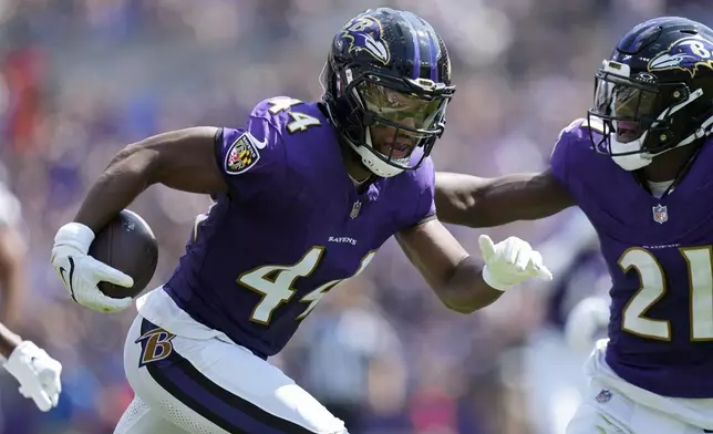 Baltimore Ravens cornerback Marlon Humphrey (44) runs with the ball after making an interception against the Las Vegas Raiders during the first half of an NFL football game, Sunday, Sept. 15, 2024, in Baltimore. (AP Photo/Stephanie Scarbrough)