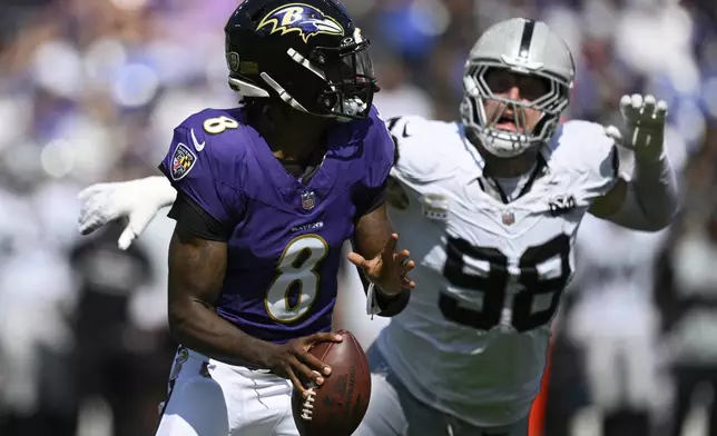 Las Vegas Raiders defensive end Maxx Crosby (98) chases after Baltimore Ravens quarterback Lamar Jackson (8) during the first half of an NFL football game, Sunday, Sept. 15, 2024, in Baltimore. (AP Photo/Nick Wass)