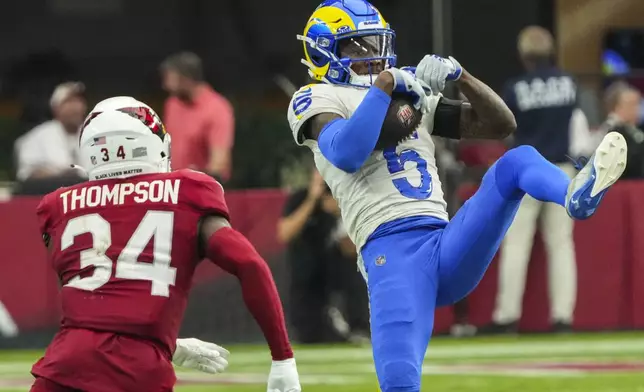 Los Angeles Rams wide receiver Tutu Atwell (5) makes a catch against Arizona Cardinals safety Jalen Thompson (34) during the second half of an NFL football game, Sunday, Sept. 15, 2024, in Glendale, Ariz. (AP Photo/Rick Scuteri)