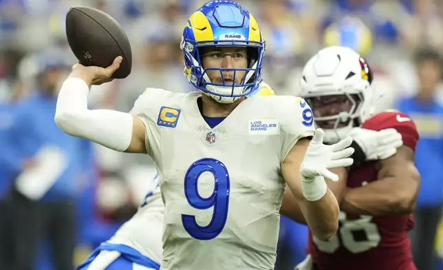 Los Angeles Rams quarterback Matthew Stafford (9) throws in the pocket against the Arizona Cardinals during the first half of an NFL football game, Sunday, Sept. 15, 2024, in Glendale, Ariz. (AP Photo/Ross D. Franklin)