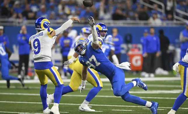 Detroit Lions defensive end Aidan Hutchinson (97) pressures Los Angeles Rams quarterback Matthew Stafford (9) during the first half of an NFL football game in Detroit, Sunday, Sept. 8, 2024. (AP Photo/David Dermer)