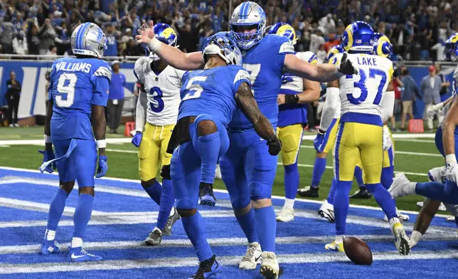 Detroit Lions running back David Montgomery (5) celebrates his one-yard touchdown run against the Los Angeles Rams during overtime in an NFL football game in Detroit, Sunday, Sept. 8, 2024. (AP Photo/David Dermer)