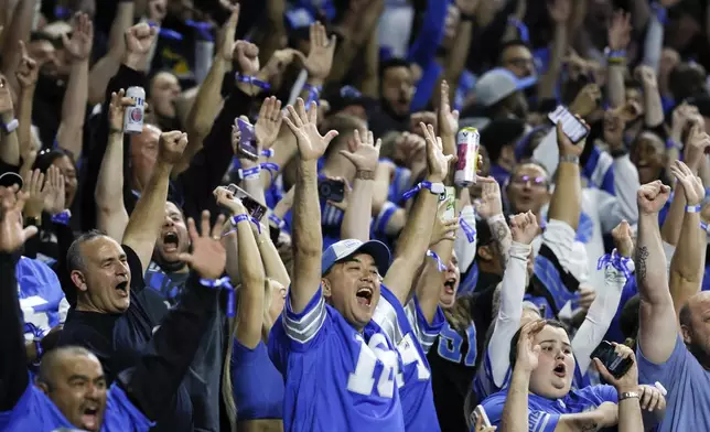 Detroit Lions fans celebrate a Detroit Lions running back Jahmyr Gibbs (26) touchdown run against the Los Angeles Rams during the first half of an NFL football game in Detroit, Sunday, Sept. 8, 2024. (AP Photo/Duane Burleson)