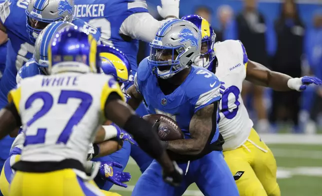 Detroit Lions running back David Montgomery (5) runs the ball against the Los Angeles Rams during the first half of an NFL football game in Detroit, Sunday, Sept. 8, 2024. (AP Photo/Duane Burleson)