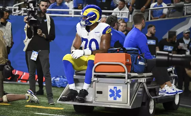 Los Angeles Rams offensive tackle Joe Noteboom (70) rides a cart to the locker room after being injured against the Detroit Lions during the first half of an NFL football game in Detroit, Sunday, Sept. 8, 2024. (AP Photo/David Dermer)