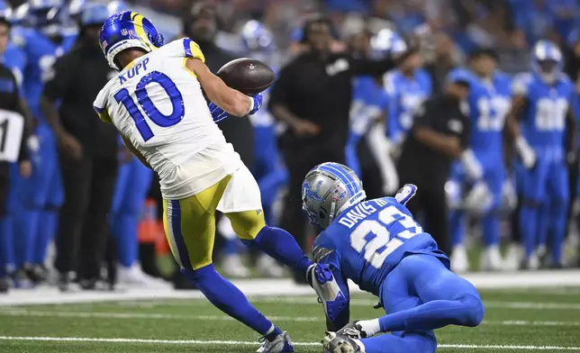 Los Angeles Rams wide receiver Cooper Kupp (10) can't hold onto a pass as Detroit Lions cornerback Carlton Davis III (23) defends during the first half of an NFL football game in Detroit, Sunday, Sept. 8, 2024. (AP Photo/David Dermer)