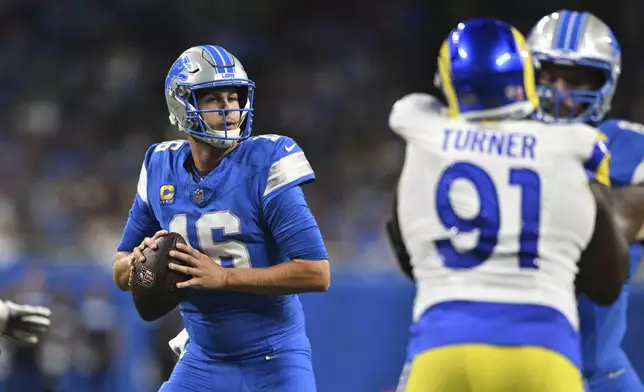 Detroit Lions quarterback Jared Goff (16) looks to throw against the Los Angeles Rams during the first half of an NFL football game in Detroit, Sunday, Sept. 8, 2024. (AP Photo/David Dermer)