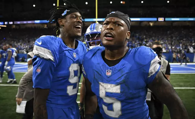 Detroit Lions running back David Montgomery (5). celebrates his one-yard touchdown run with Jameson Williams (9) against the Los Angeles Rams during overtime in an NFL football game in Detroit, Sunday, Sept. 8, 2024. (AP Photo/David Dermer)