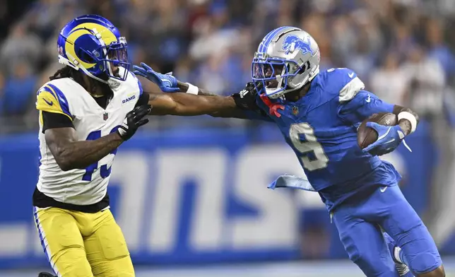 Detroit Lions wide receiver Jameson Williams (9) stiff-arms Los Angeles Rams safety John Johnson III (43) during the first half of an NFL football game in Detroit, Sunday, Sept. 8, 2024. (AP Photo/David Dermer)