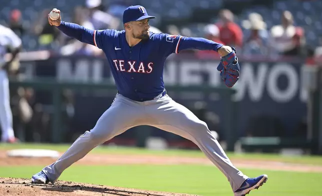 Texas Rangers' Nathan Eovaldi pitches during the first inning of a baseball game against the Los Angeles Angels, Sunday, Sept. 29, 2024, in Anaheim, Calif. (AP Photo/John McCoy)