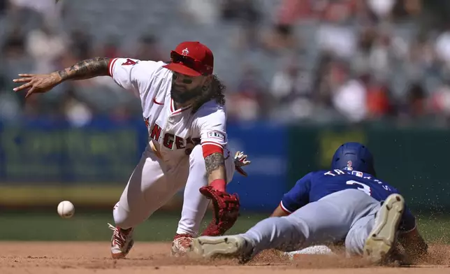 Texas Rangers' Leody Taveras steals second as Los Angeles Angels shortstop Jack López reaches for the ball during the seventh inning of a baseball game, Sunday, Sept. 29, 2024, in Anaheim, Calif. (AP Photo/John McCoy)