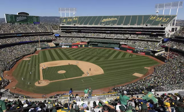 Fans attend a baseball game between the Oakland Athletics and the Texas Rangers, Thursday, Sept. 26, 2024, in Oakland, Calif. (AP Photo/Benjamin Fanjoy)