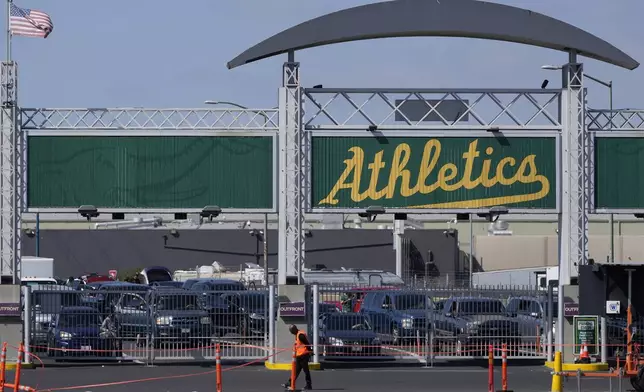 Cars wait to enter the Oakland Coliseum parking lot before a baseball game between the Oakland Athletics and the Texas Rangers in Oakland, Calif., Wednesday, Sept. 25, 2024. (AP Photo/Jeff Chiu)