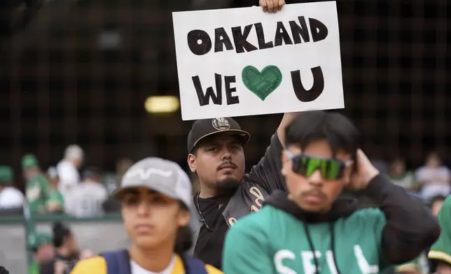 An Oakland Athletics fan holds up a sign before a baseball game against the Texas Rangers, Thursday, Sept. 26, 2024, in Oakland, Calif. (AP Photo/Godofredo A. Vásquez)