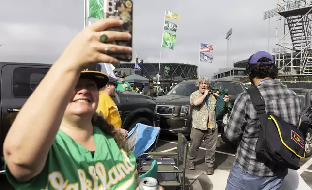 Andrew Johnstone plays the bagpipes outside the Oakland Coliseum before a baseball game between the Oakland Athletics and the Texas Rangers Thursday, Sept. 26, 2024, in Oakland, Calif. (AP Photo/Benjamin Fanjoy)