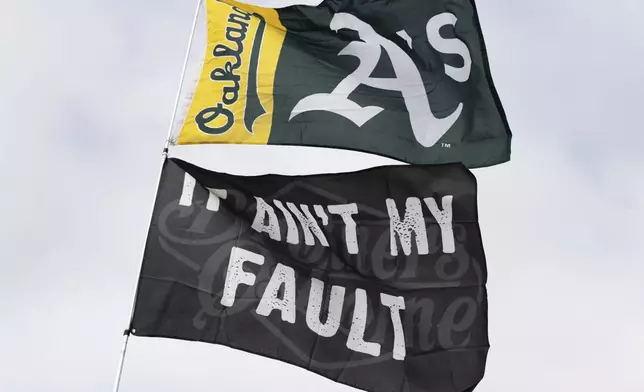 An Oakland Athletics flag flies outside the Oakland Coliseum before a baseball game between the Oakland Athletics and the Texas Rangers Thursday, Sept. 26, 2024, in Oakland, Calif. (AP Photo/Benjamin Fanjoy)