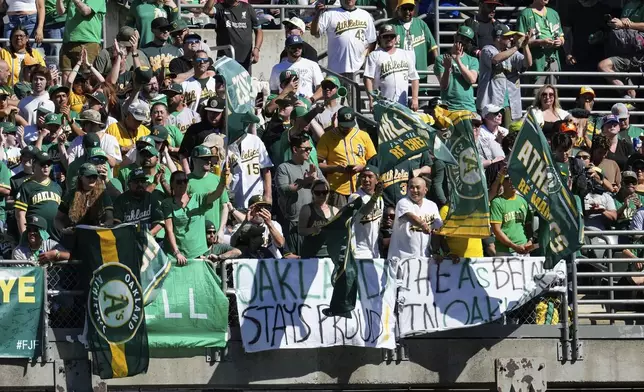 Oakland Athletics fans cheer during the eighth inning of a baseball game against the Texas Rangers, Thursday, Sept. 26, 2024, in Oakland, Calif. (AP Photo/Godofredo A. Vásquez)