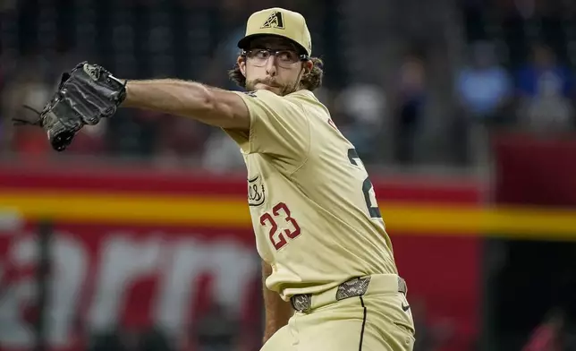 Arizona Diamondbacks pitcher Zac Gallen throws against the Texas Rangers during the first inning of a baseball game, Tuesday, Sept. 10, 2024, in Phoenix. (AP Photo/Darryl Webb)