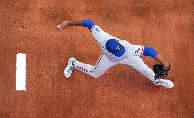 Texas Rangers starting pitcher Kumar Rocker warms up before his major league debut against the Seattle Mariners in a baseball game Thursday, Sept. 12, 2024, in Seattle. (AP Photo/Lindsey Wasson)