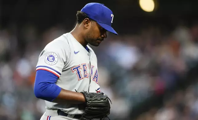 Texas Rangers starting pitcher Kumar Rocker walks back to the dugout after facing the Seattle Mariners during the second inning of a baseball game Thursday, Sept. 12, 2024, in Seattle. (AP Photo/Lindsey Wasson)