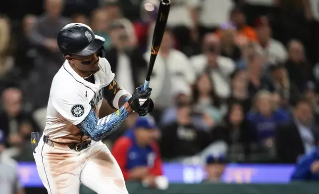 Seattle Mariners' Julio Rodríguez strikes out to end the game in a 5-4 loss to the Texas Rangers in a baseball game Thursday, Sept. 12, 2024, in Seattle. (AP Photo/Lindsey Wasson)