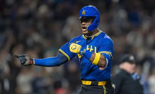 Seattle Mariners' Julio Rodriguez celebrates after hitting a solo home run during the third inning of a baseball game against the Texas Rangers, Saturday, Sept. 14, 2024, in Seattle. (AP Photo/Stephen Brashear)