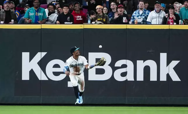 Seattle Mariners center fielder Julio Rodríguez catches the double hit by Texas Rangers' Wyatt Langford after it bounces in front of him during the eighth inning of a baseball game Thursday, Sept. 12, 2024, in Seattle. (AP Photo/Lindsey Wasson)