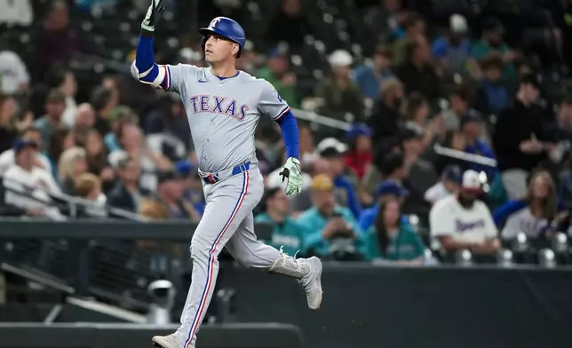 Texas Rangers' Nathaniel Lowe jogs the bases after hitting a solo home run against the Seattle Mariners during the seventh inning of a baseball game Thursday, Sept. 12, 2024, in Seattle. (AP Photo/Lindsey Wasson)