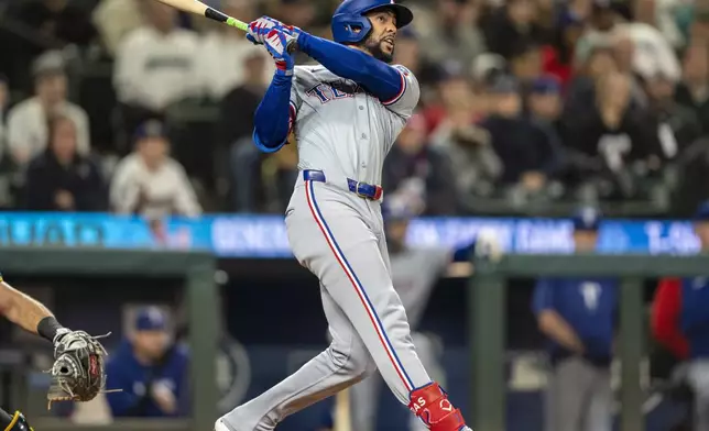 Texas Rangers' Leody Taveras hits a two-run home run during the third inning of a baseball game against the Seattle Mariners, Saturday, Sept. 14, 2024, in Seattle. (AP Photo/Stephen Brashear)