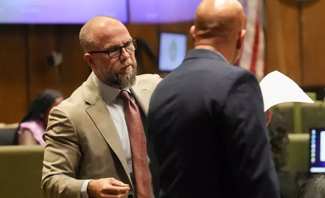 Defendant Justin Johnson's attorney Luke Evans, left, speaks with Paul Hagerman, Shelby County deputy district attorney, right, during Johnson's trial for the murder of rapper Young Dolph, Tuesday, Sept. 24, 2024, in Memphis, Tenn. (AP Photo/George Walker IV, Pool)