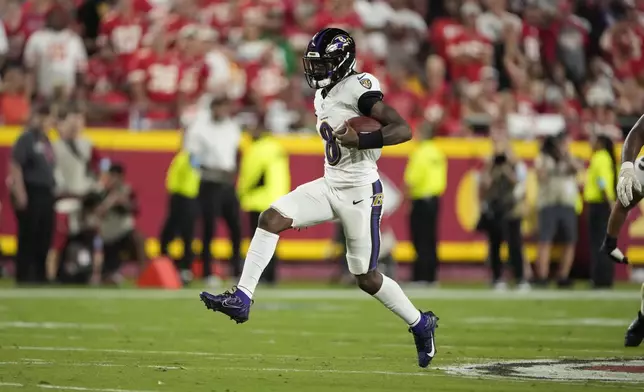 Baltimore Ravens quarterback Lamar Jackson runs with the ball during the first half of an NFL football game against the Kansas City Chiefs Thursday, Sept. 5, 2024, in Kansas City, Mo. (AP Photo/Charlie Riedel)