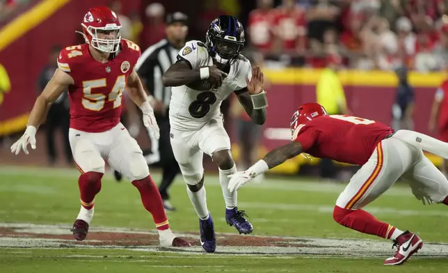 Baltimore Ravens quarterback Lamar Jackson (8) runs with the ball as Kansas City Chiefs safety Bryan Cook, right, and linebacker Leo Chenal (54) defend during the second half of an NFL football game Thursday, Sept. 5, 2024, in Kansas City, Mo. (AP Photo/Charlie Riedel)