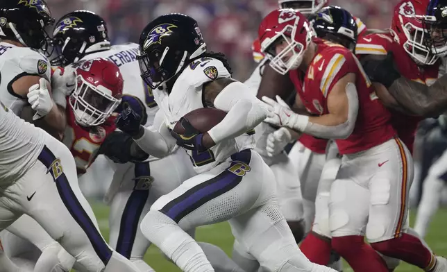 Baltimore Ravens running back Derrick Henry runs with the ball during the first half of an NFL football game against the Kansas City Chiefs Thursday, Sept. 5, 2024, in Kansas City, Mo. (AP Photo/Ed Zurga)