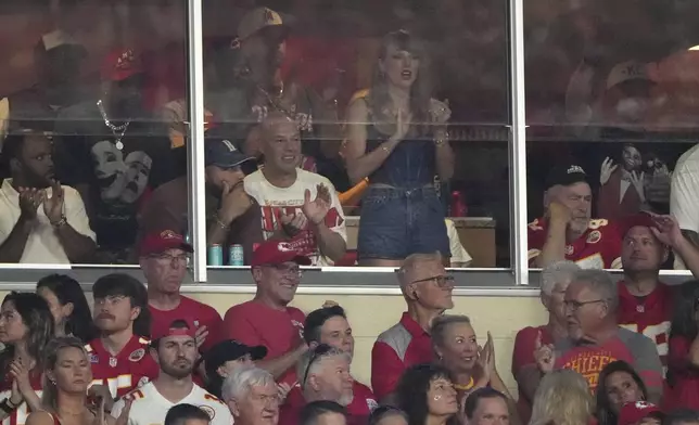 Taylor Swift is seen in a suite during the first half of an NFL football game between the Kansas City Chiefs and the Baltimore Ravens Thursday, Sept. 5, 2024, in Kansas City, Mo. (AP Photo/Charlie Riedel)