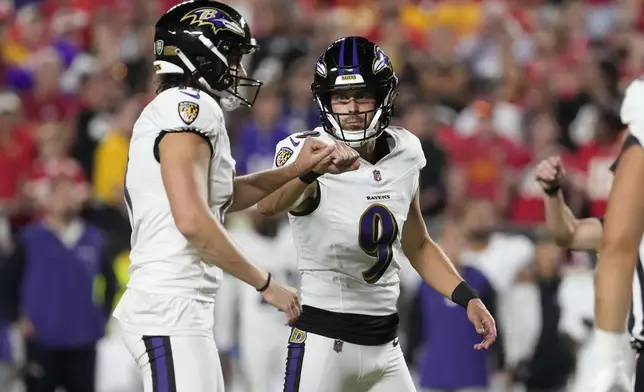 Baltimore Ravens kicker Justin Tucker (9) is congratulated by teammate Jordan Stout after making a 25-yard field goal during the first half of an NFL football game against the Kansas City Chiefs Thursday, Sept. 5, 2024, in Kansas City, Mo. (AP Photo/Ed Zurga)