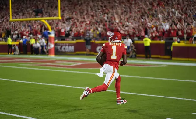 Kansas City Chiefs wide receiver Xavier Worthy heads for the end zone after catching a 35-yard pass for a touchdown during the second half of an NFL football game against the Baltimore Ravens Thursday, Sept. 5, 2024, in Kansas City, Mo. (AP Photo/Charlie Riedel)